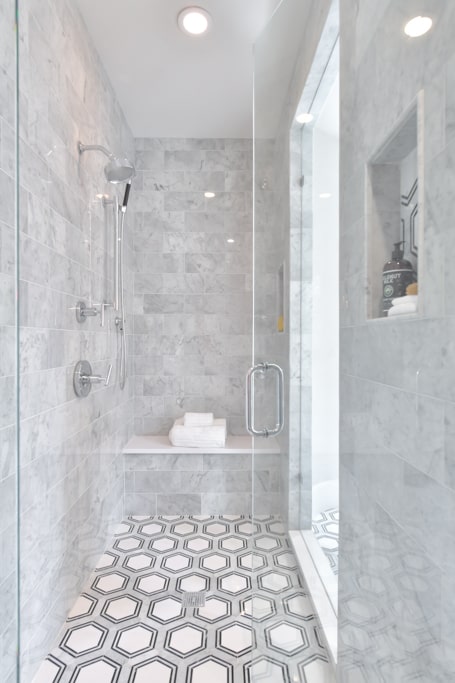 Luxury spa shower with marble and patterned tile