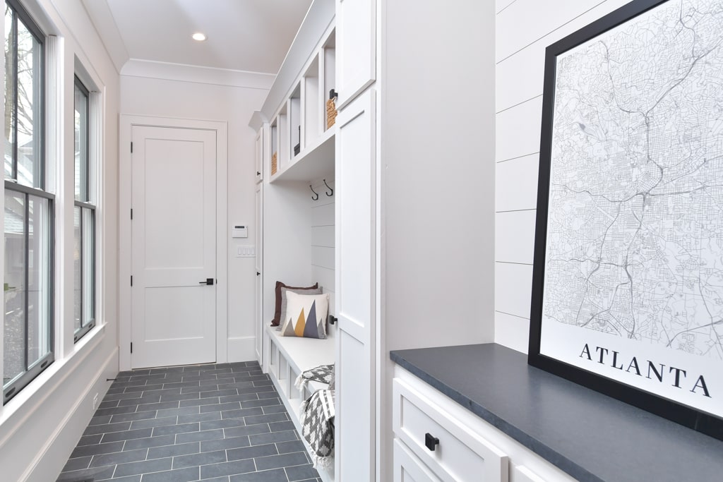 A robustly functional mudroom with built in shelving and seating is perfect for bustling families.
